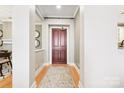Inviting entryway with hardwood floors and a classic dark wood door at 572 N Church St, Charlotte, NC 28202