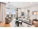 Bright living room with floor-to-ceiling windows and a comfortable seating arrangement at 572 N Church St, Charlotte, NC 28202