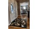 Inviting foyer with decorative tile inlay, hardwood floors, and a view into the dining room at 591 Bent Oak Trl, Concord, NC 28027
