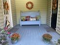 Cozy front porch featuring a decorative bench and seasonal decor for a welcoming entrance at 591 Bent Oak Trl, Concord, NC 28027