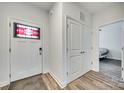 Inviting foyer featuring a decorative glass front door and wood-look flooring at 611 N York St, Gastonia, NC 28052