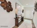 Stylish foyer featuring wood floors, decorative wall art, and a console table with elegant decor at 6271 Fairfax Ct, Maiden, NC 28650