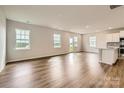 Bright and spacious living room featuring wood floors, recessed lighting, and multiple windows for ample natural light at 6277 Fairfax Ct, Maiden, NC 28650