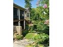 Backyard view featuring a two-story brick house with a screened porch and lush landscaping at #92 Silver Trace Ln, Denver, NC 28037