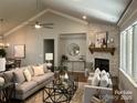Spacious living room boasts a stone fireplace, large windows, and modern furnishings at #92 Silver Trace Ln, Denver, NC 28037