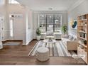 Bright living room featuring stylish furniture, a large window, and neutral colors for a cozy feel at 11124 Chastain Parc Dr, Charlotte, NC 28216