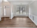 Bright living room with large window, white trim and hardwood floors at 11124 Chastain Parc Dr, Charlotte, NC 28216