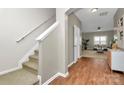 Inviting foyer featuring a staircase, hardwood floors, and an open view to the bright living area at 137 Woodbridge Cir, Mount Holly, NC 28120