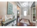 Inviting foyer with hardwood floors, elegant lighting, and decorative accents, setting a stylish tone at 14827 Batteliere Dr, Charlotte, NC 28278