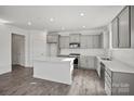 Modern kitchen with stainless steel appliances, white countertops, and sleek gray cabinetry at 15015 Meadows Hunt Ln # 164, Huntersville, NC 28078