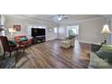 Bright living room with hardwood floors, fireplace, and large windows at 1612 Forum Ln, Iron Station, NC 28080