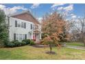 Charming two-story home with gray siding, shingle accents, manicured landscaping, and inviting front porch at 16415 Kelly Park Cir, Huntersville, NC 28078