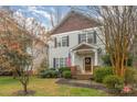 Charming two-story home with gray siding, shingle accents, manicured landscaping, and inviting front porch at 16415 Kelly Park Cir, Huntersville, NC 28078