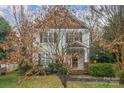 Charming two-story home with gray siding, shingle accents, manicured landscaping, and inviting front porch at 16415 Kelly Park Cir, Huntersville, NC 28078