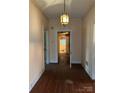 View of the hallway with wood floor and a doorway to a bathroom at 201 N Crawford St, Monroe, NC 28112