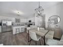Elegant dining area open to the kitchen, featuring modern lighting and neutral tones at 212 Briana Marie Way, Indian Trail, NC 28079