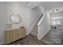 Welcoming entryway featuring a staircase, wood-look flooring, and stylish decor at 212 Briana Marie Way, Indian Trail, NC 28079