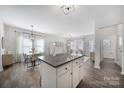 Open-concept living space with granite island, seamlessly connecting the kitchen and living areas at 212 Briana Marie Way, Indian Trail, NC 28079