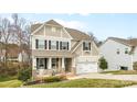 Charming two-story home features a covered front porch and a two-car garage at 3114 Woodlands Creek Dr, Monroe, NC 28110