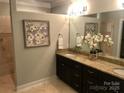 Bathroom featuring a double vanity with granite countertop, framed art, and modern fixtures at 32 Shanklin S Ln # 32, Denver, NC 28037