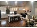 Open-concept space with kitchen island, dining area, and living room with hardwood flooring at 32 Shanklin S Ln # 32, Denver, NC 28037