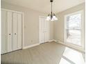 Neutral dining room featuring a large window, light wood floors and two closets at 4210 Wrangler Sw Dr, Concord, NC 28027