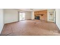 Spacious living room featuring a brick fireplace and sliding glass doors at 4210 Wrangler Sw Dr, Concord, NC 28027