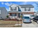Charming two-story home with brick and siding, a welcoming front porch, and a well-maintained yard and driveway at 4716 Meadowfield Rd, Charlotte, NC 28215