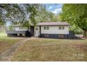 Charming two-story home featuring a white exterior with black brick accents and a well-maintained front yard at 7407 Forney Hill Rd, Denver, NC 28037