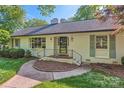 Inviting exterior showcasing a white brick facade, neat landscaping, and a stylish entrance at 7613 Whistlestop Rd, Charlotte, NC 28210
