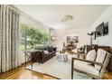 Bright living room with hardwood floors, large windows, and elegant furnishings at 7613 Whistlestop Rd, Charlotte, NC 28210
