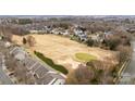 Aerial view of a residential area with golf course and many houses at 8412 Brookings Dr, Charlotte, NC 28269