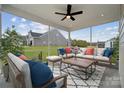 Screened porch featuring a ceiling fan and comfortable seating area with an outdoor rug at 884 Exeter Dr, Sherrills Ford, NC 28673
