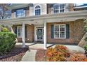 Inviting front porch with brick columns and manicured garden bed at 11000 King George Ln, Waxhaw, NC 28173