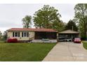Charming single-story home with a well-manicured lawn and a detached carport at 115 Setter Ct, Statesville, NC 28625