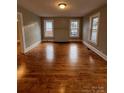 Inviting living room featuring beautiful hardwood floors and natural light from multiple windows at 120 3Rd Ave, Conover, NC 28613