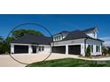Beautiful two-story home featuring white siding, black roof, and a spacious three-car garage at 129 Ryleigh Dan Pl, Mooresville, NC 28115