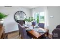 Stylishly arranged dining room with view to outdoors, set table, large mirror, and modern decor at 1416 6Th Ne St, Hickory, NC 28601