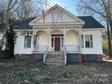 Charming two-story home featuring a classic front porch with decorative trim details at 148 Center St, Chester, SC 29706