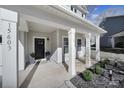 Charming front porch with white columns, a dark front door, and stylish potted plants at 15603 Pine Glen Ct, Charlotte, NC 28273