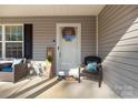 Inviting front porch with chairs and decorations adding a touch of curb appeal to the home at 3041 Mulberry Ln, Lancaster, SC 29720