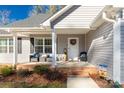 Charming front porch with decorative wreath and sitting area for relaxing and enjoying the outdoors at 3041 Mulberry Ln, Lancaster, SC 29720