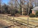 Spacious yard featuring a rustic wooden fence, mature trees, and natural landscaping at 314 Little St, Lincolnton, NC 28092