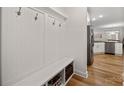 Functional mudroom with built-in storage, hooks, and bench seating, leading to the kitchen at 3899 Center Place Dr, Harrisburg, NC 28075