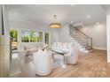 Bright living room features hardwood floors, a cozy fireplace, and elegant chandelier lighting at 4008 Nettie Ct # 3, Charlotte, NC 28211