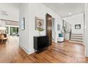 Bright foyer boasts hardwood floors, modern staircase, and stylish decor, creating a welcoming entrance to the home at 5520 Chedworth Dr, Charlotte, NC 28210