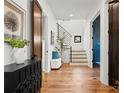 Hallway with hardwood floors, modern staircase, and decorative accents at 5520 Chedworth Dr, Charlotte, NC 28210