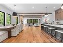 Spacious open floorplan combining the dining, living, and kitchen areas with hardwood flooring at 5610 Farmbrook Dr, Charlotte, NC 28210