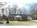 Charming brick house with a neatly kept lawn and inviting front porch seating at 583 Old Wilkesboro Rd, Taylorsville, NC 28681