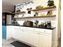 Bright kitchen boasts open shelving, white cabinets, and sleek countertops at 583 Old Wilkesboro Rd, Taylorsville, NC 28681